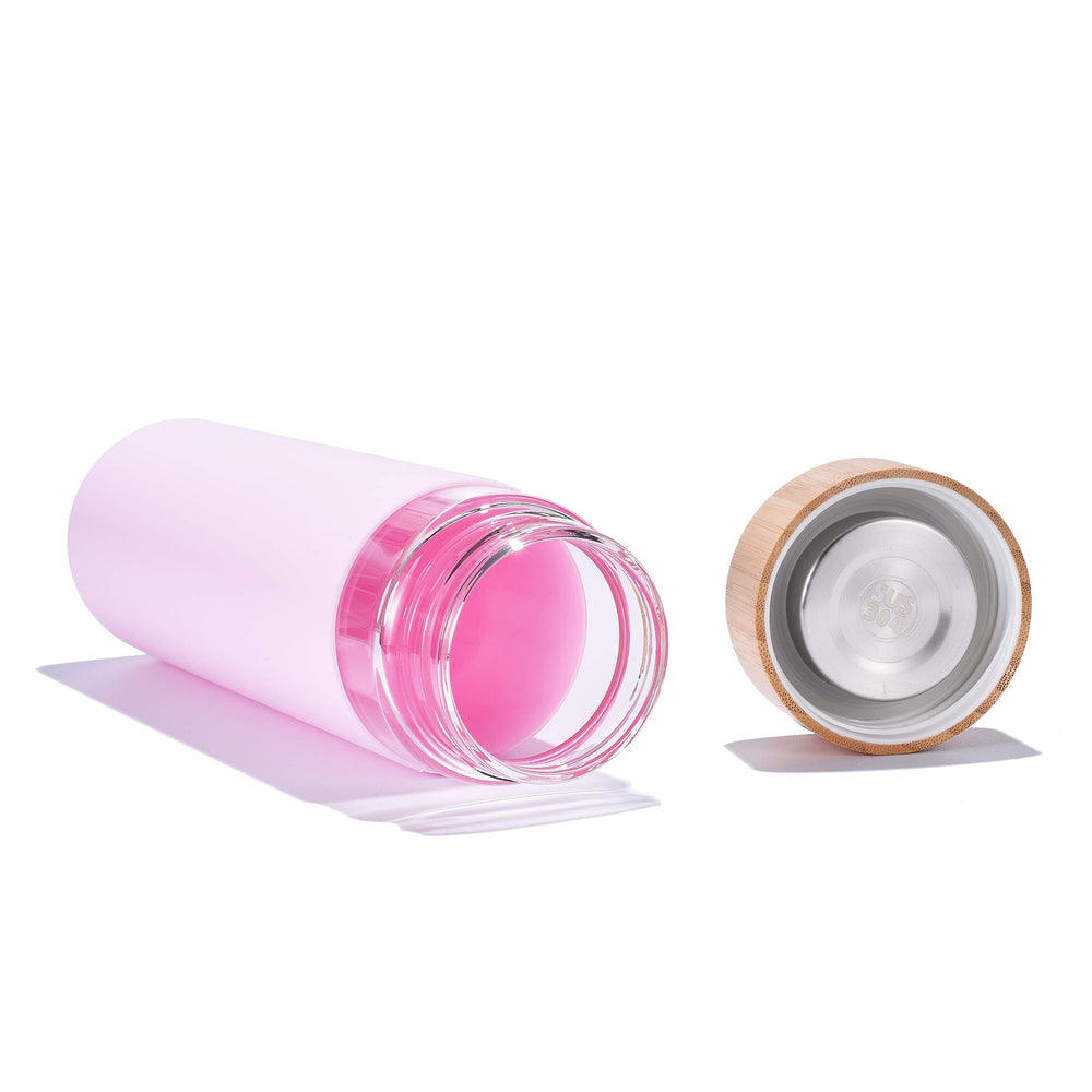 Yomious bottle next to smartphone showing 20 oz size and portability