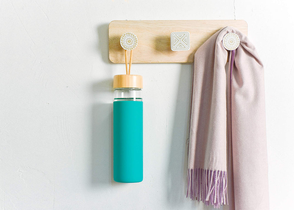 Yomious bottle held in hand for scale illustrating ergonomic 20 oz capacity