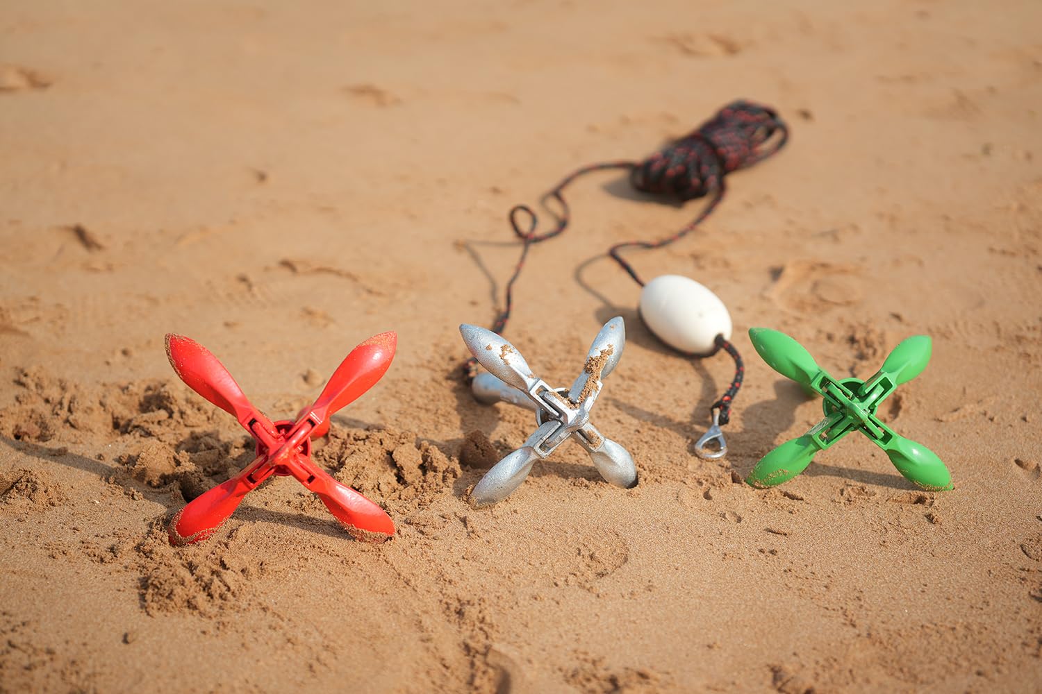 Young Marine folded anchor beside hand for scale showing compactness and transport convenience