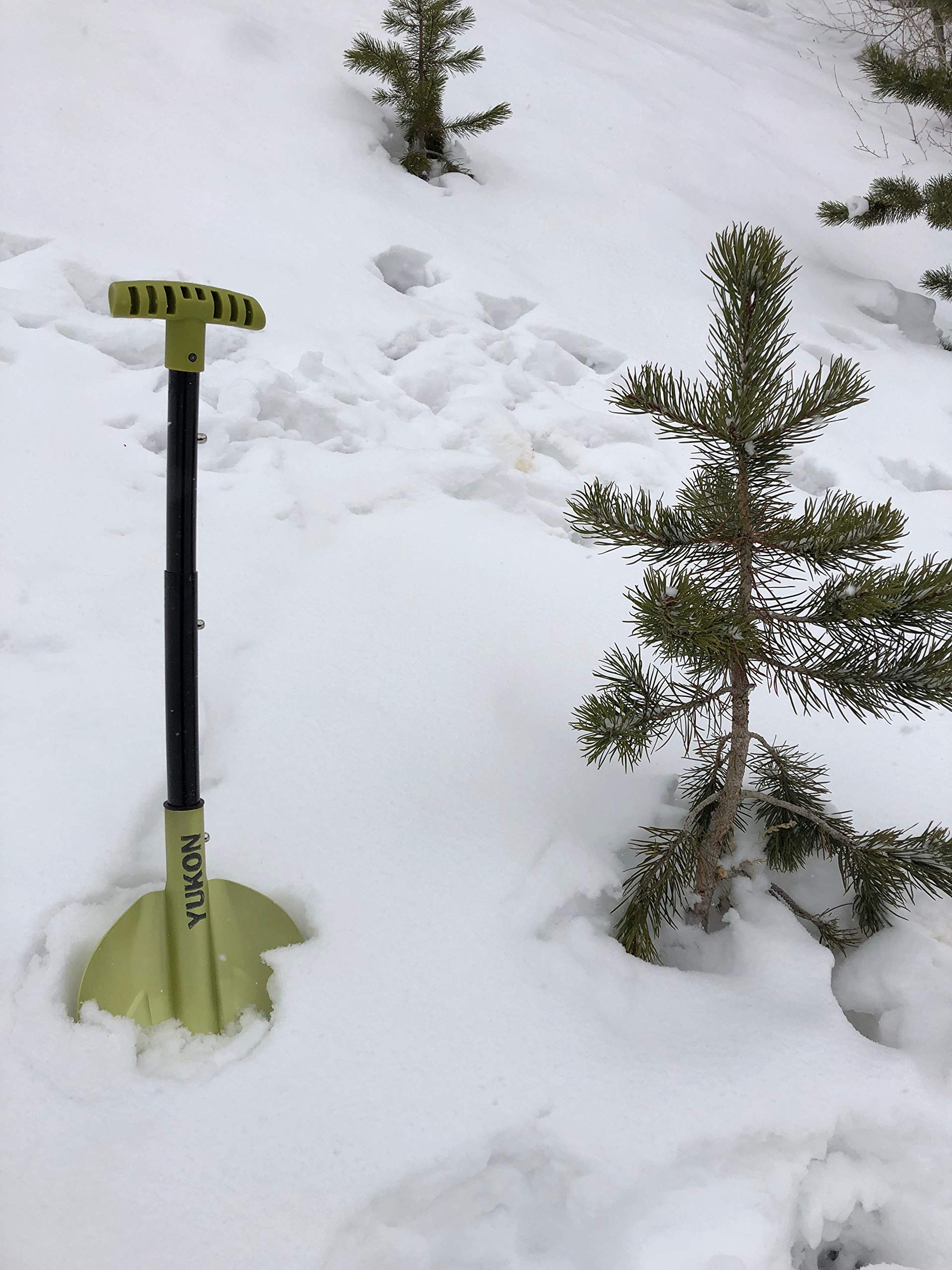Yukon Charlie's compact shovel stored in a car trunk for emergencies