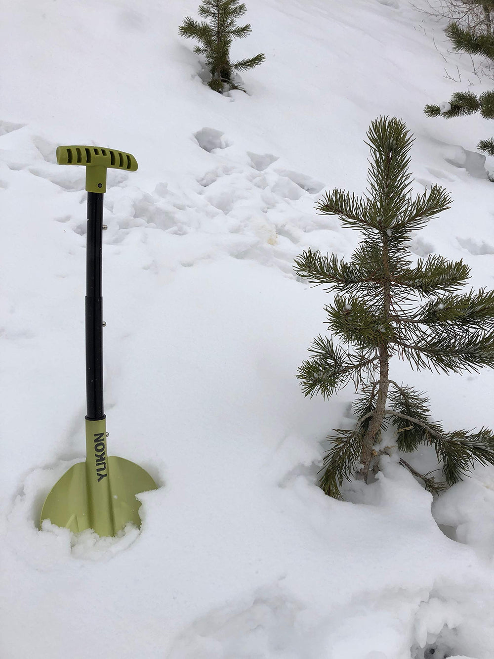 Yukon Charlie's compact shovel stored in a car trunk for emergencies