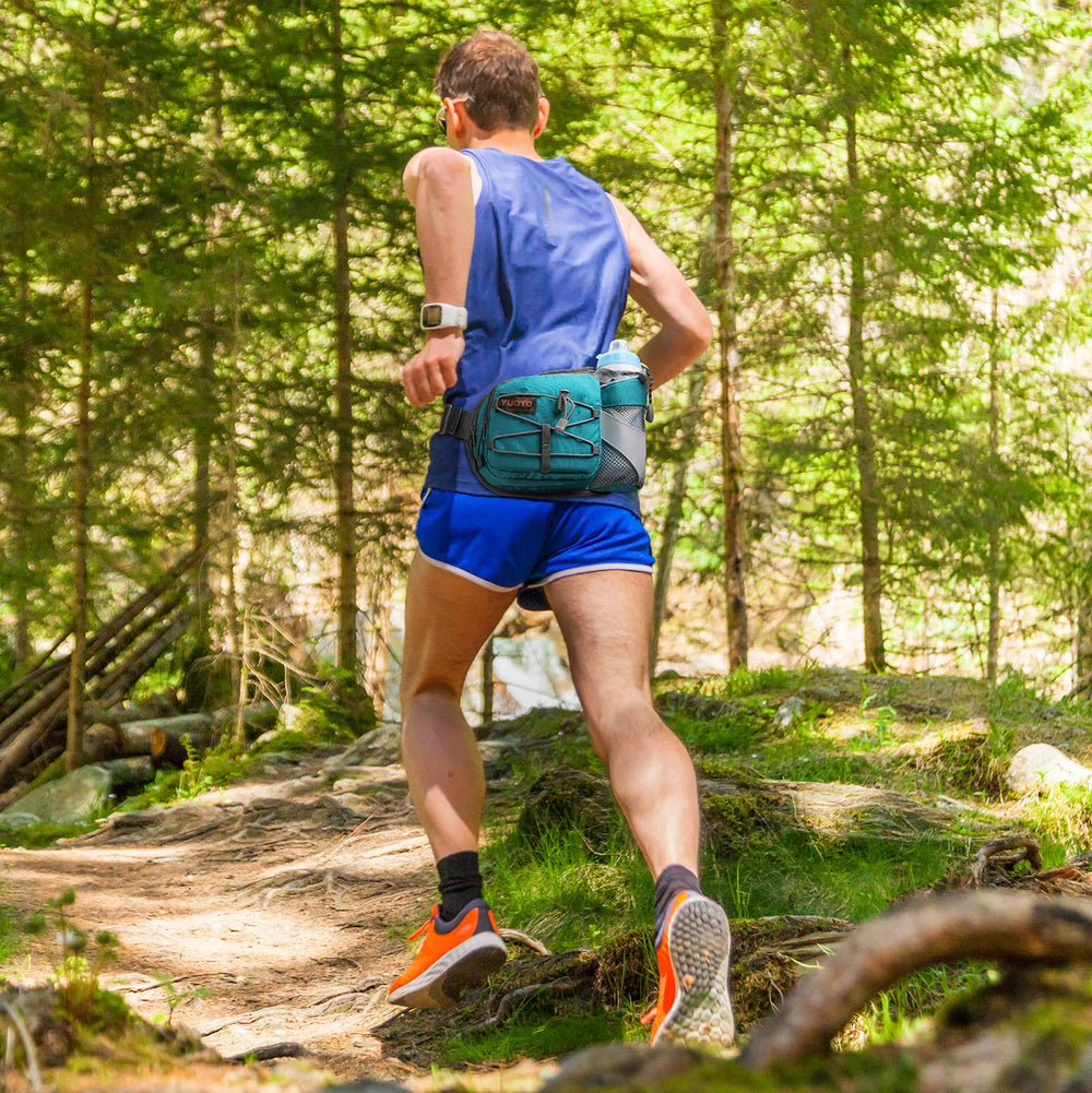 YUOTO lifestyle shot of runner wearing the pack on a trail, hands-free hydration