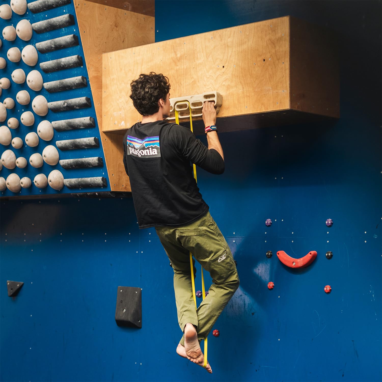YY Vertical beside a climber's hand to show scale and comfortable grip depth for progressive training